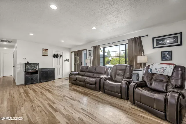 a living room with furniture and a open kitchen