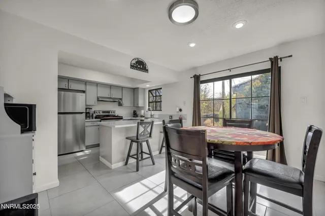 a view of a dining room with furniture and a window