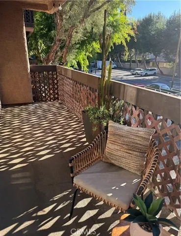 a view of a wooden deck with potted plants