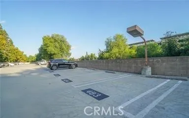 a view of a parking space and a car parked on road