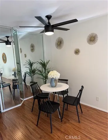 a view of a room with furniture and wooden floor