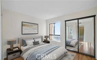 a bedroom with a large bed and a lamp