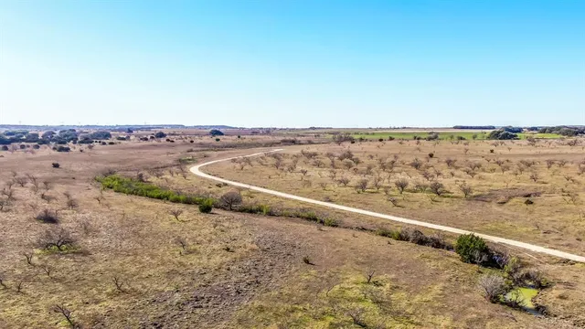 a view of a field with an ocean view