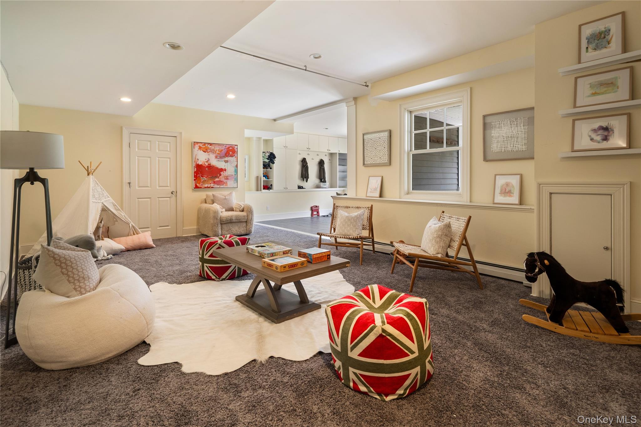 77 Byram Ridge Road Armonk, NY 10504 - Photo 39 of 48 Lower level large playroom/rec room, door to nanny room/office (not pictured) ,full bath (not pictured), workroom/walk-in closet (not pictured), dog room with doggy door out (not pictured)