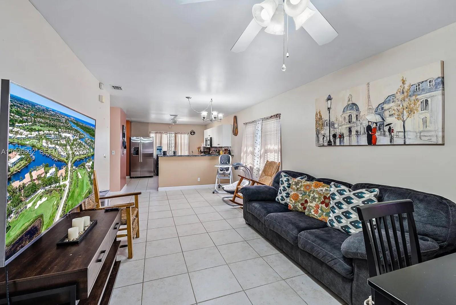 1303 West 6th Street Riviera Beach, FL 33404 - Photo 3 of 4 a living room with furniture and a flat screen tv