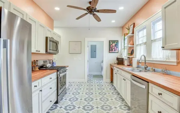 a kitchen with stainless steel appliances a sink stove and refrigerator