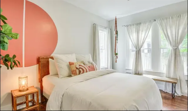 a bedroom with a large bed and a large window