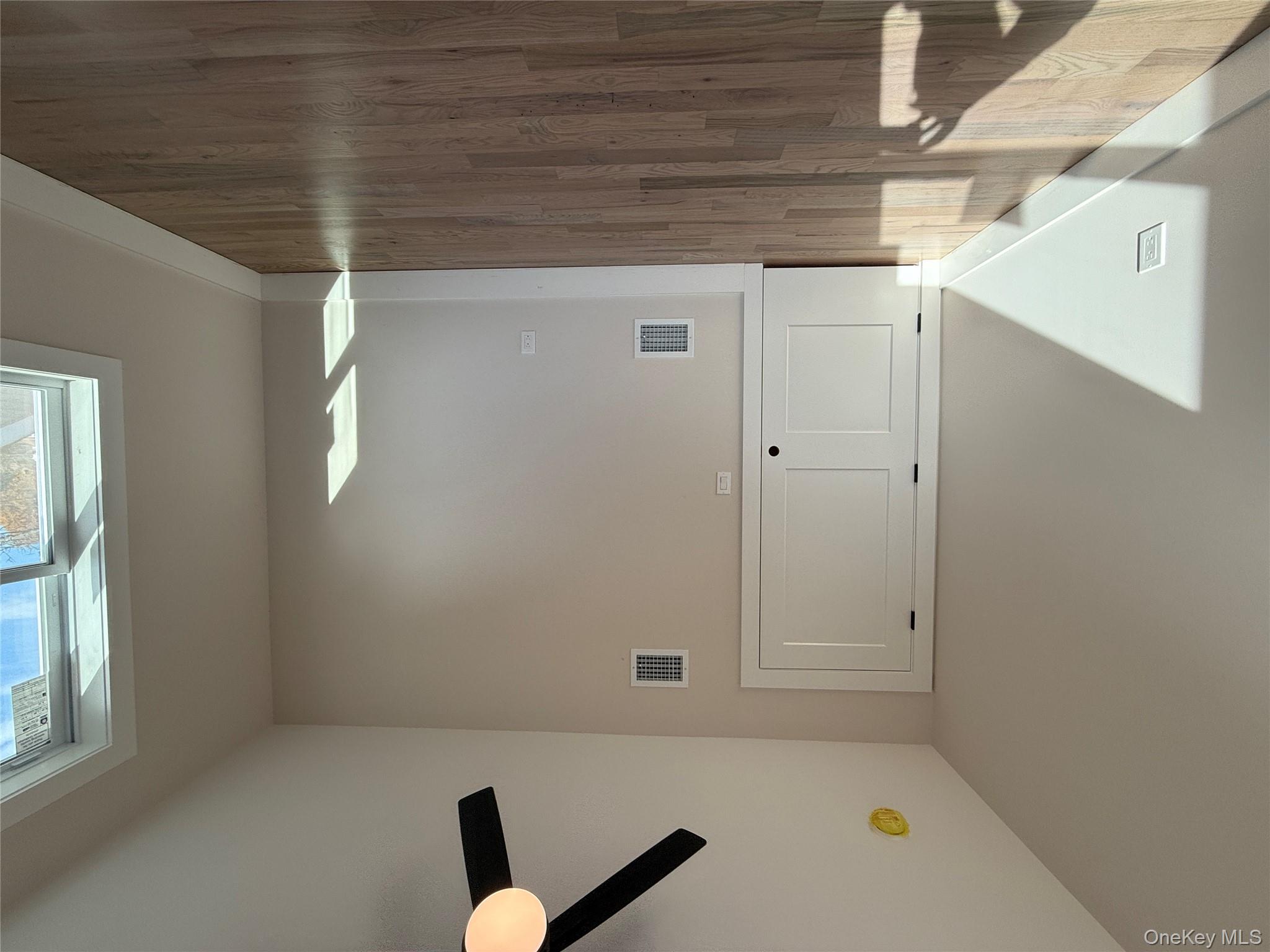 New Construction Rugby Drive Shirley, NY 11967 - Photo 13 of 17 a view of an empty room with wooden floor and a window