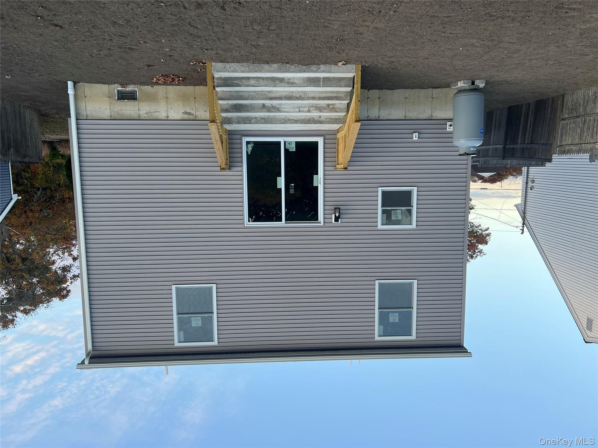 New Construction Rugby Drive Shirley, NY 11967 - Photo 2 of 17 a front view of a house with a garage