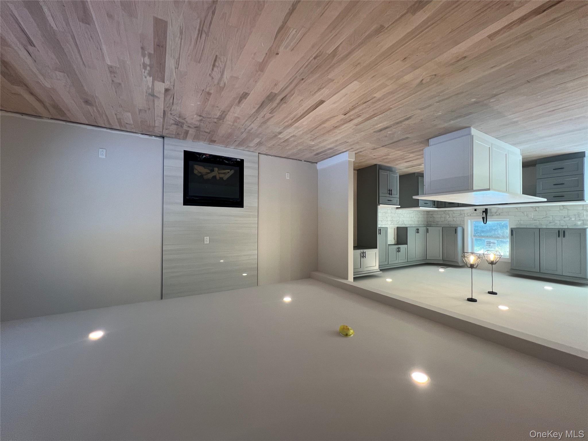 New Construction Rugby Drive Shirley, NY 11967 - Photo 4 of 17 an empty room with wooden floor and a kitchen