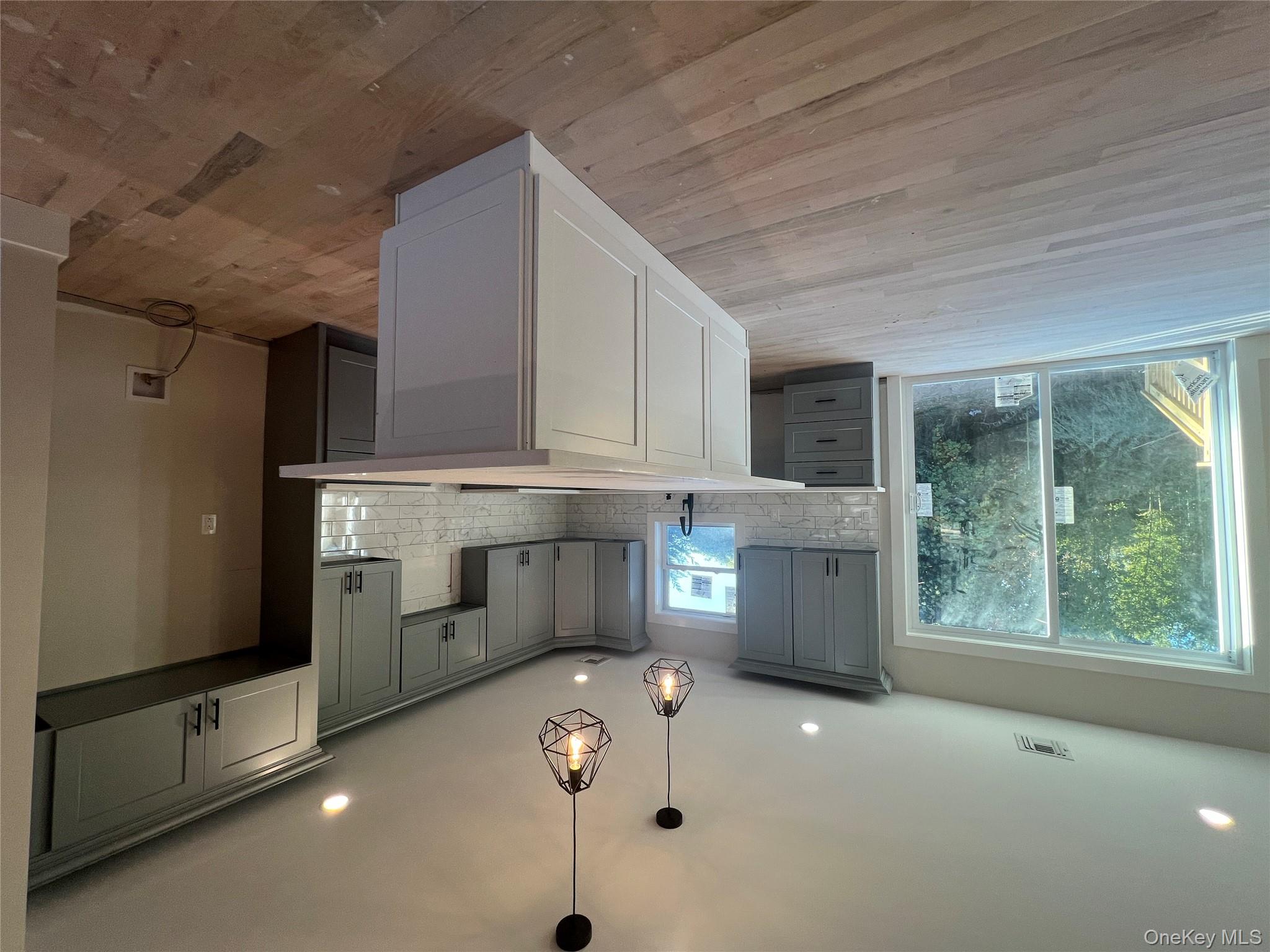 New Construction Rugby Drive Shirley, NY 11967 - Photo 5 of 17 a large kitchen with kitchen island a large counter top a sink stainless steel appliances and cabinets