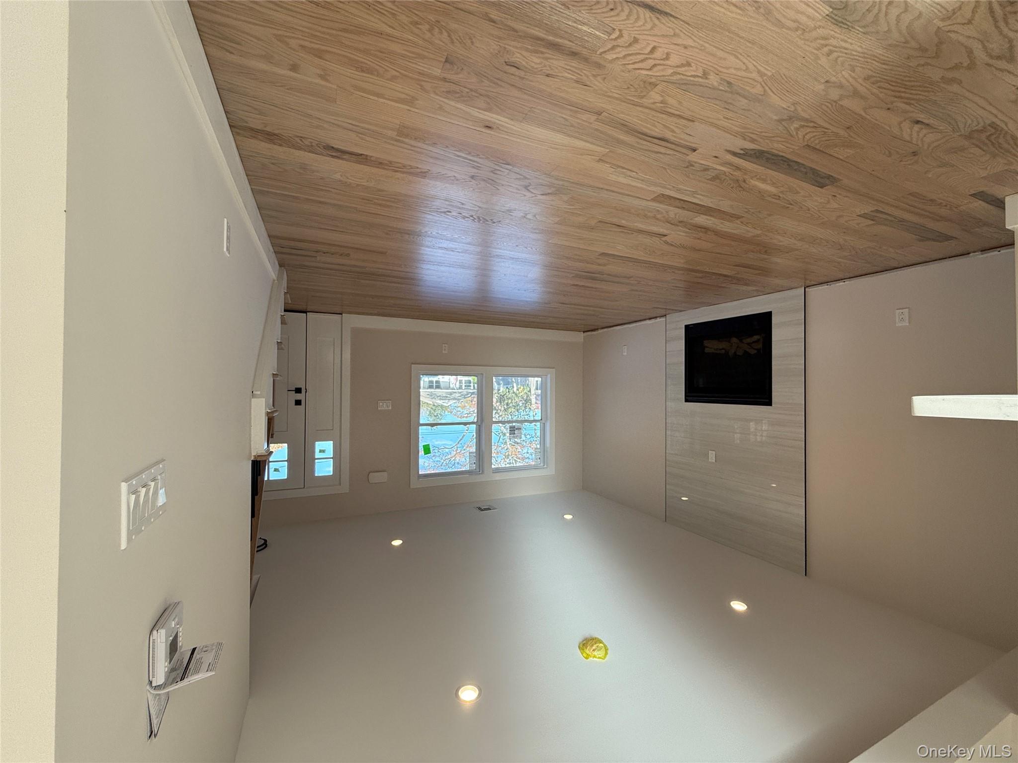 New Construction Rugby Drive Shirley, NY 11967 - Photo 6 of 17 an empty room with wooden floor and windows