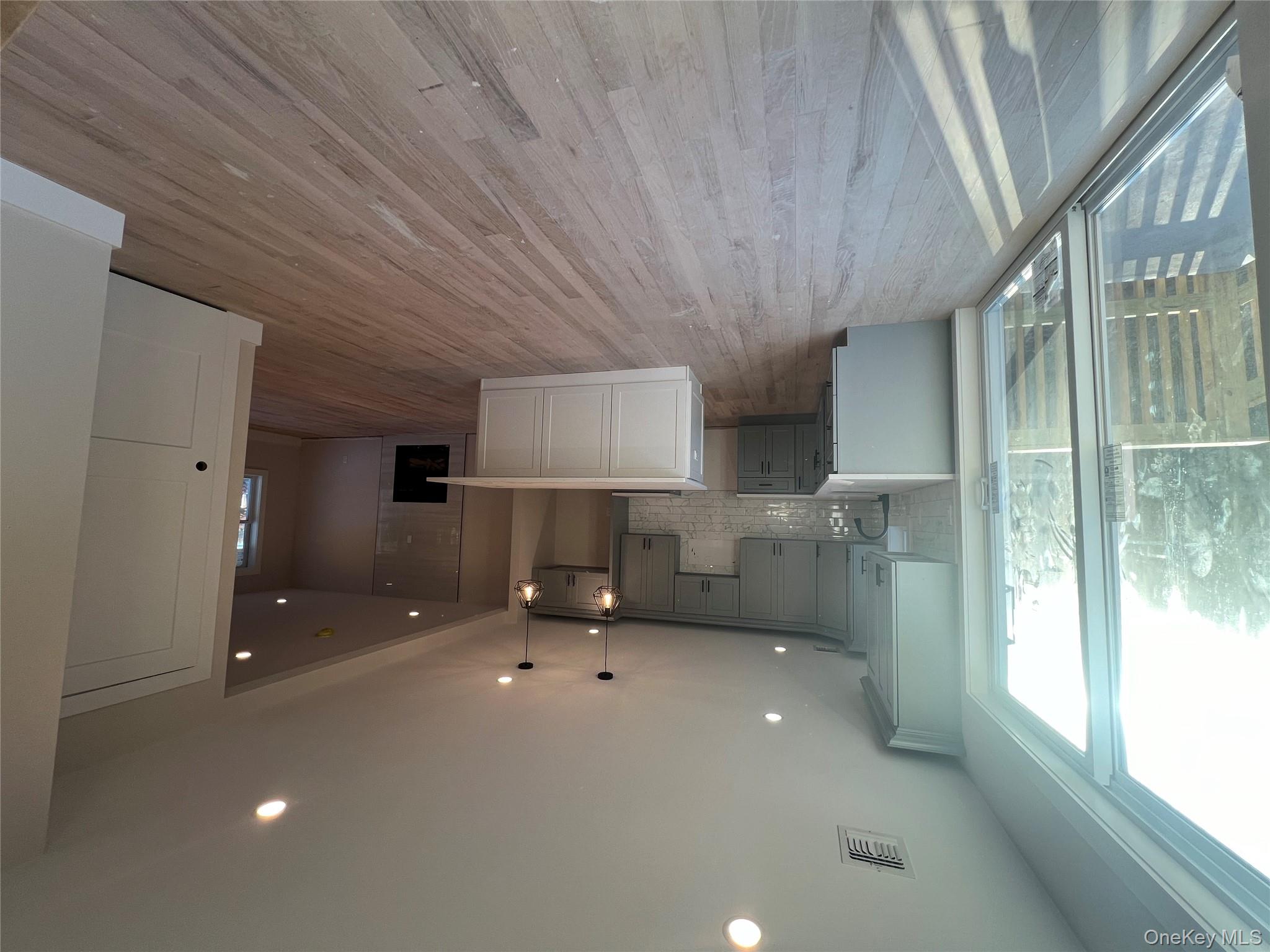 New Construction Rugby Drive Shirley, NY 11967 - Photo 7 of 17 a living room with stainless steel appliances furniture wooden floor and a large window