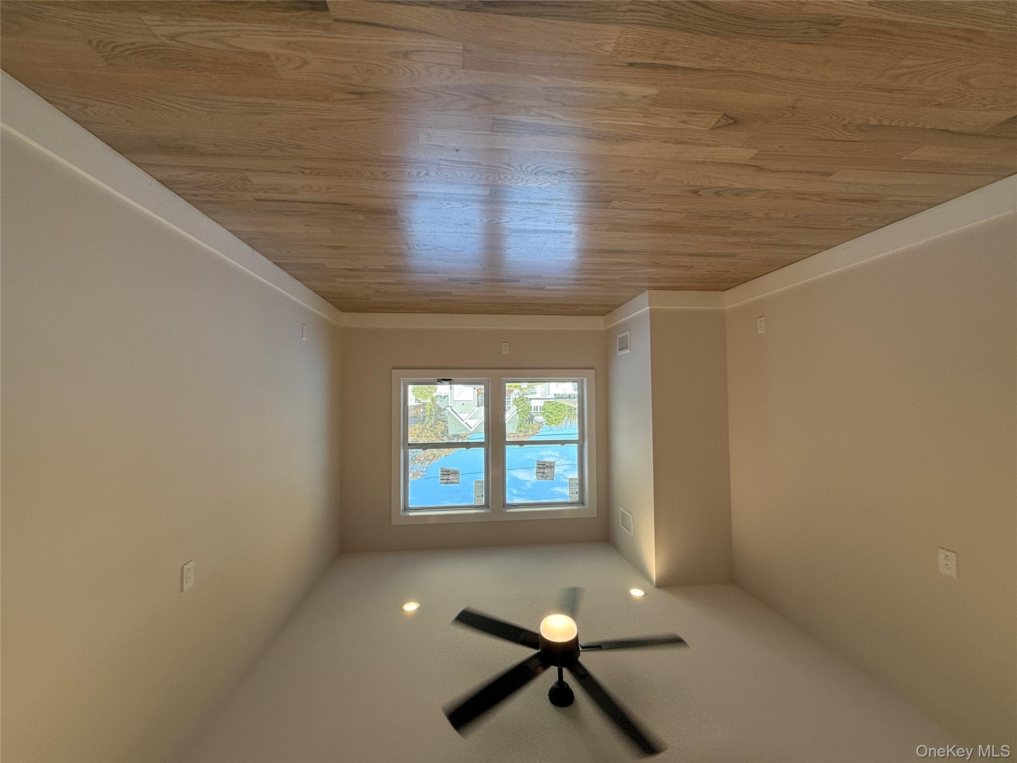 New Construction Rugby Drive Shirley, NY 11967 - Photo 9 of 17 an empty room with wooden floor and windows