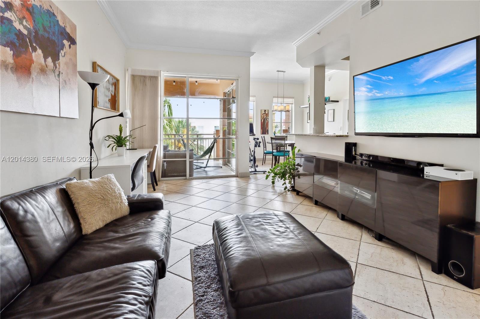 100 Meridian Avenue, Unit 244 Miami Beach, FL 33139 - Photo 1 of 18 a living room with furniture and a flat screen tv