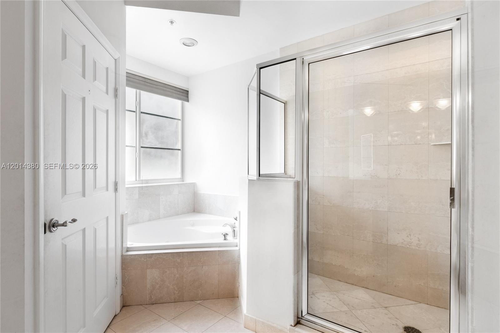 100 Meridian Avenue, Unit 244 Miami Beach, FL 33139 - Photo 11 of 18 a bathroom with a tub shower and window