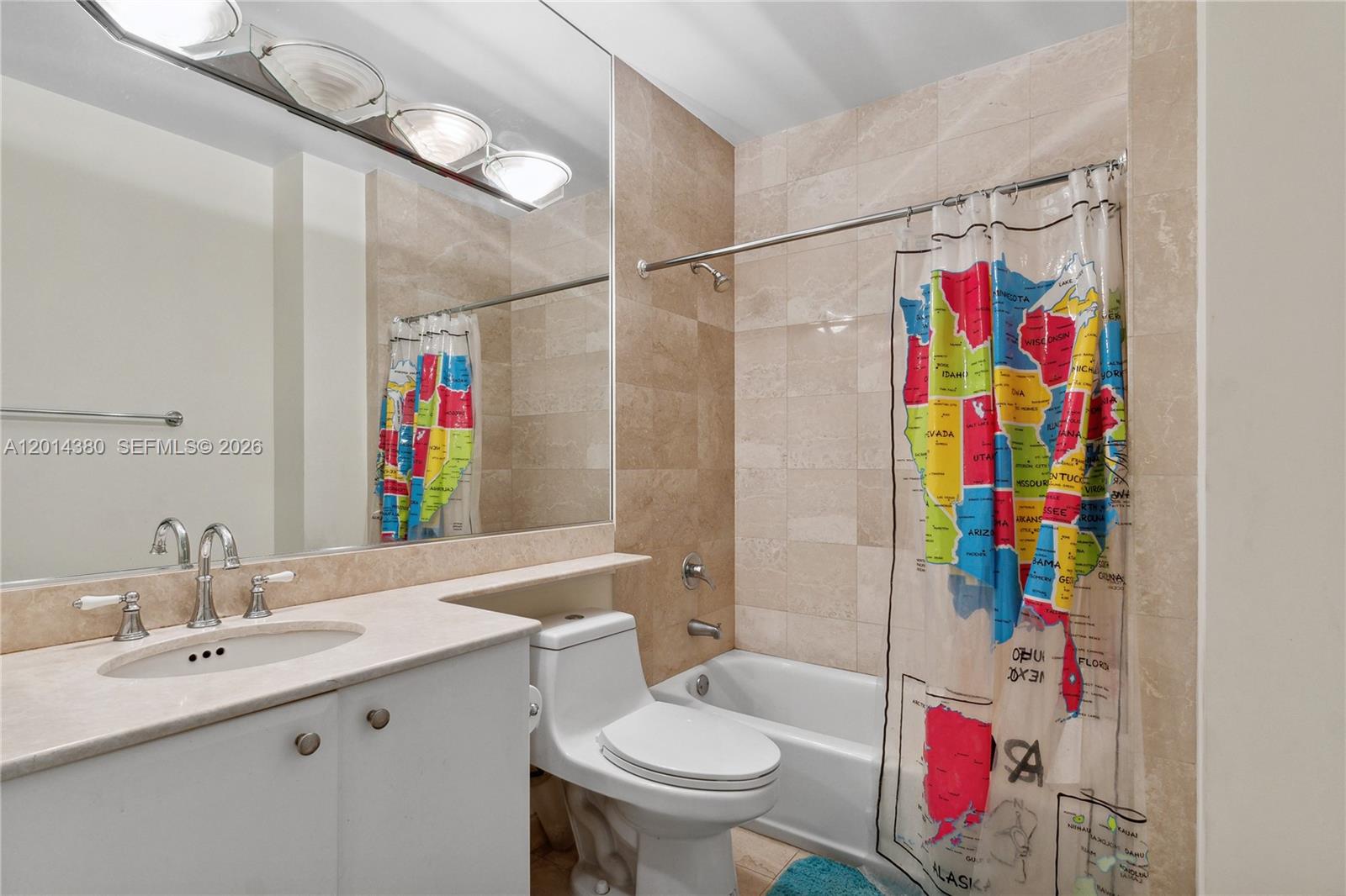 100 Meridian Avenue, Unit 244 Miami Beach, FL 33139 - Photo 13 of 18 a bathroom with a sink a toilet and a shower curtain