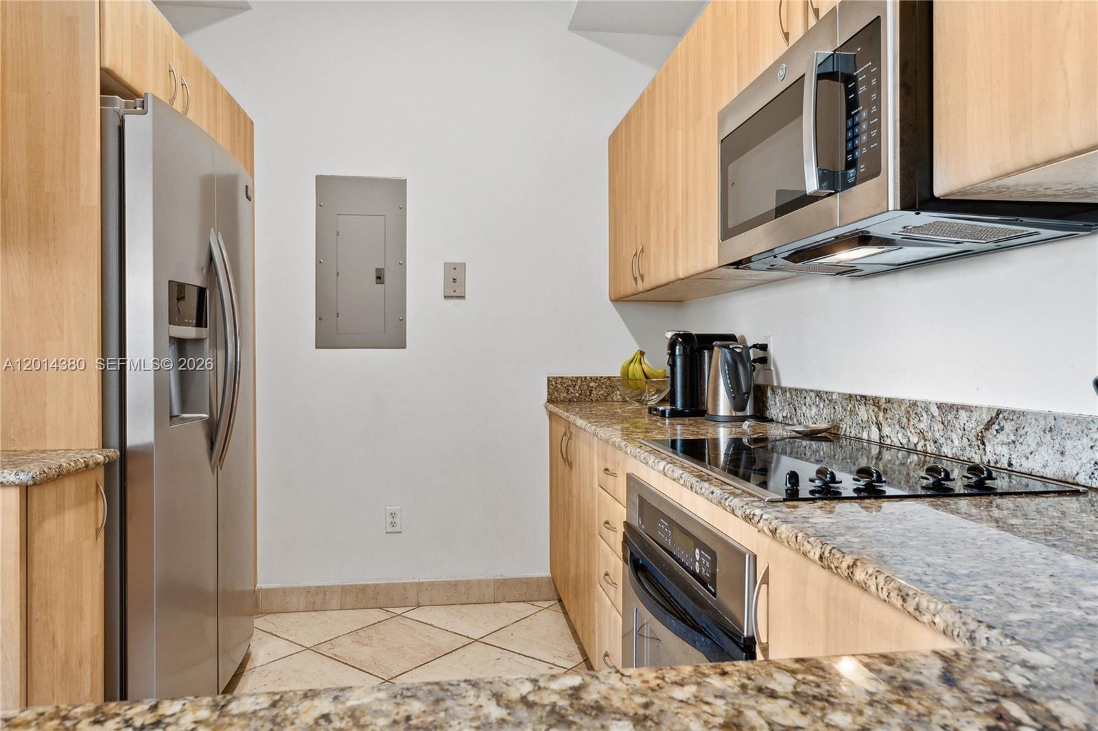 100 Meridian Avenue, Unit 244 Miami Beach, FL 33139 - Photo 3 of 18 a kitchen with stainless steel appliances granite countertop a sink a stove and a refrigerator