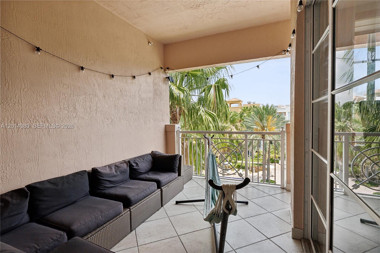 100 Meridian Avenue, Unit 244 Miami Beach, FL 33139 - Photo 5 of 18 a living room with furniture and a floor to ceiling window