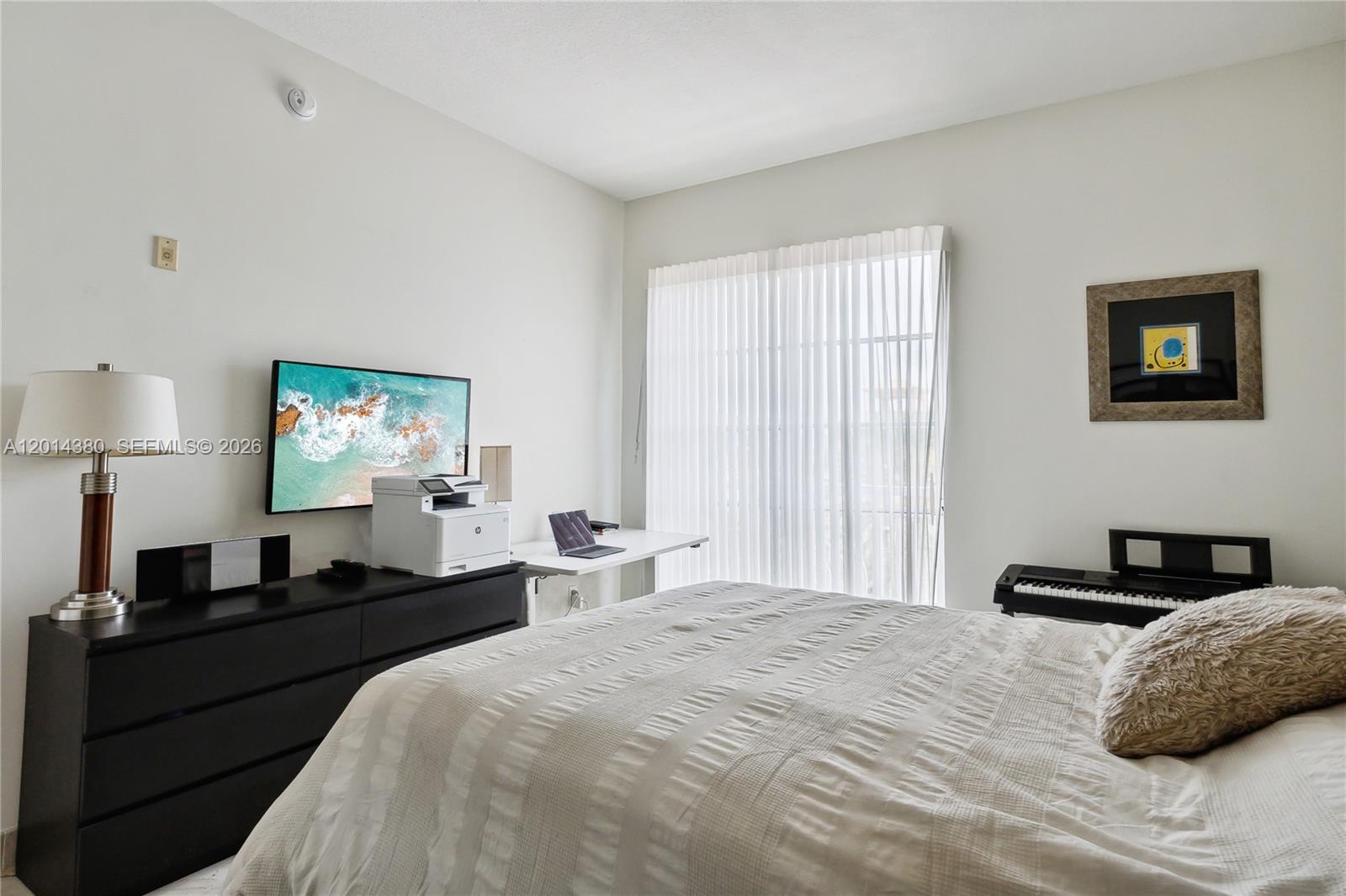 100 Meridian Avenue, Unit 244 Miami Beach, FL 33139 - Photo 9 of 18 a bedroom with a bed and a lamp