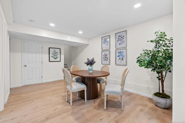 a view of a dining room with furniture and a potted plant