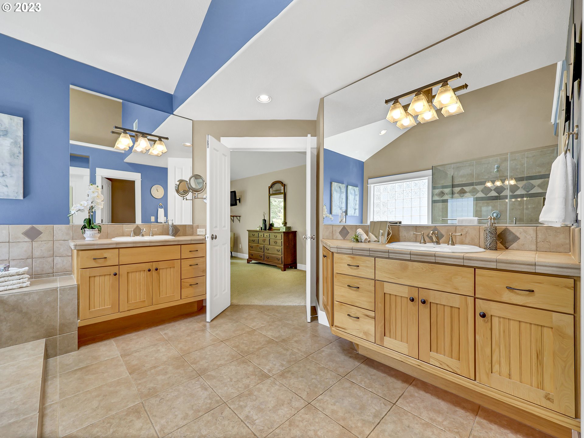 9965 Southwest Choctaw Street Tualatin, OR 97062 - Photo 17 of 25 a spacious bathroom with a granite countertop sink mirror and a