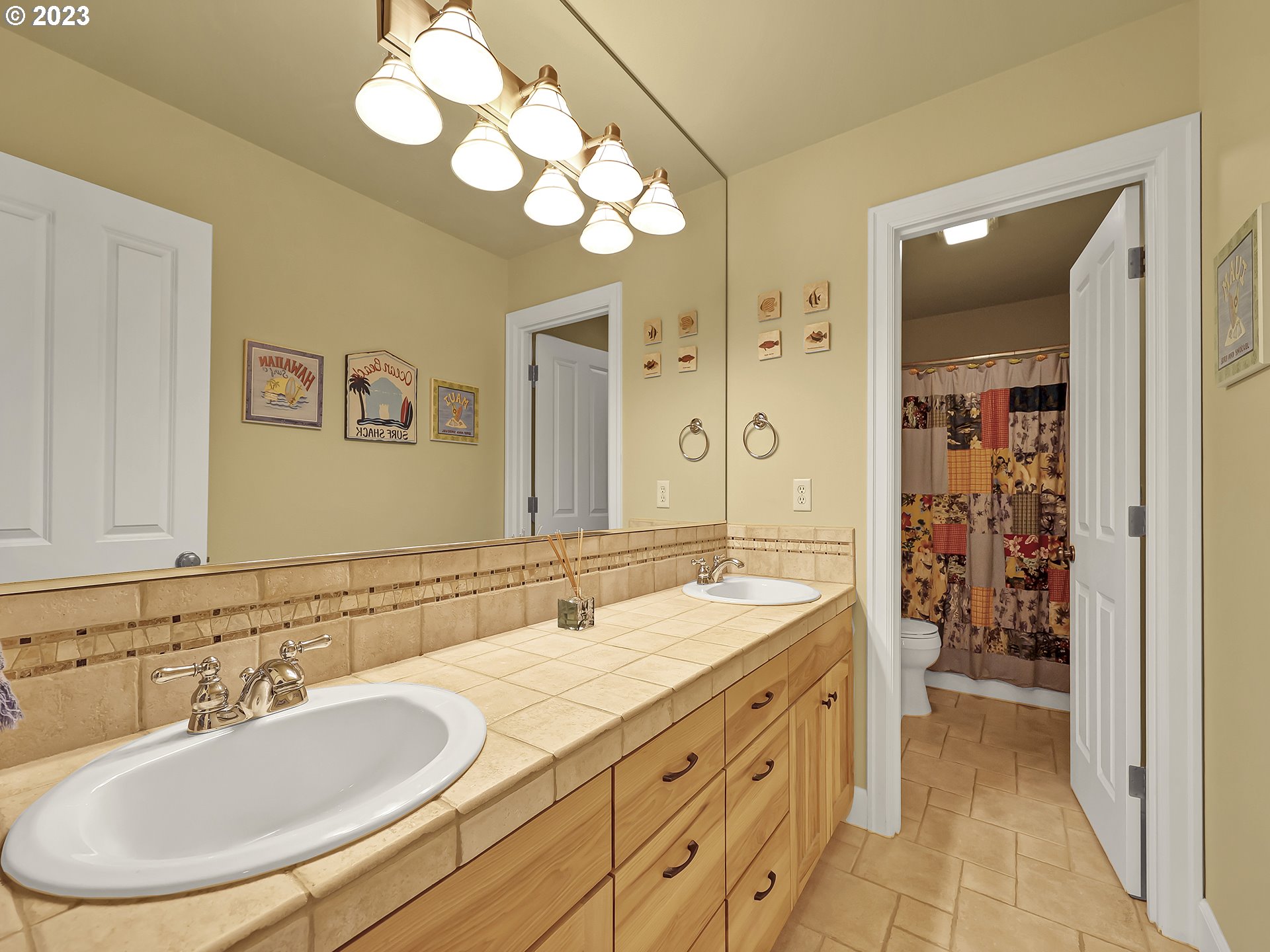 9965 Southwest Choctaw Street Tualatin, OR 97062 - Photo 19 of 25 a bathroom with double vanity sinks and a mirror