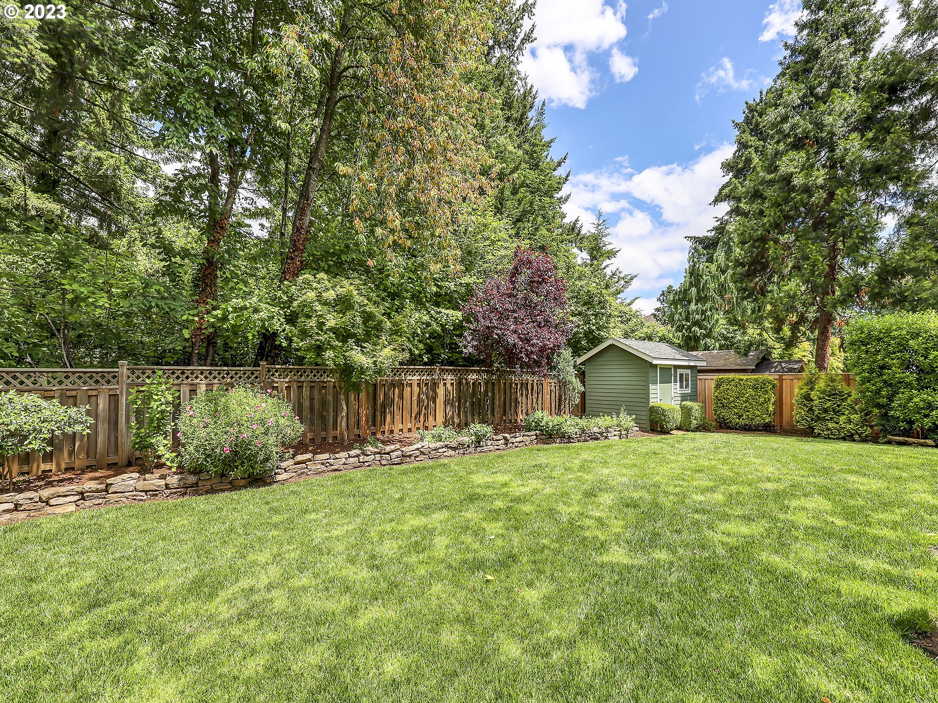 9965 Southwest Choctaw Street Tualatin, OR 97062 - Photo 25 of 25 a backyard of a house with lots of green space