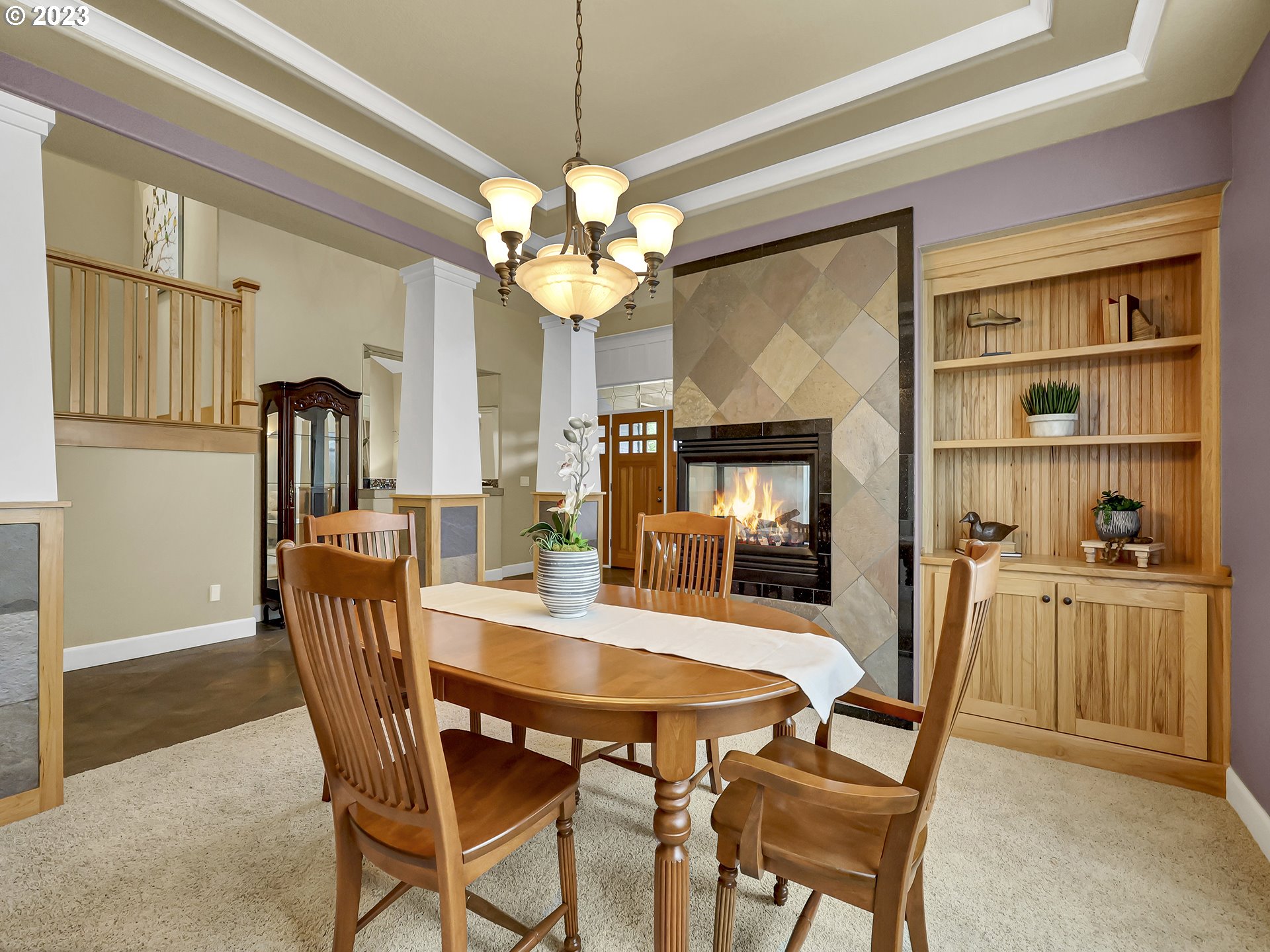 9965 Southwest Choctaw Street Tualatin, OR 97062 - Photo 5 of 25 a dining room with furniture a chandelier and wooden floor