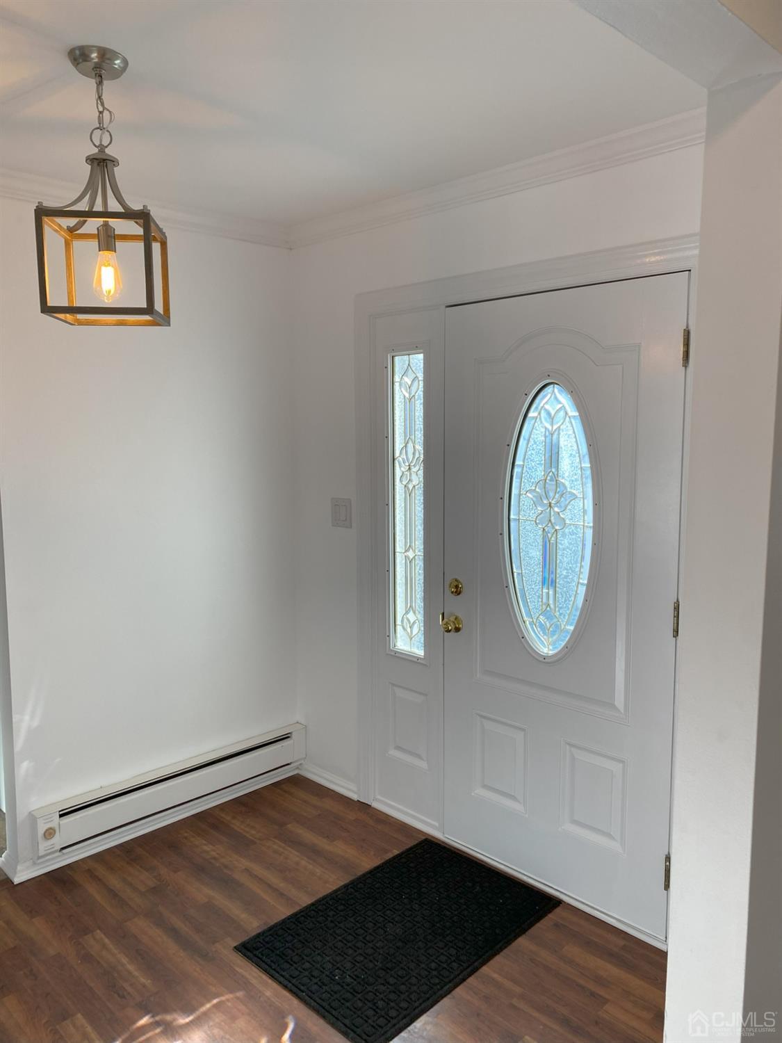 A Zacatin Road Freehold, NJ 07728 - Photo 2 of 25 an empty room with wooden floor cabinet and windows