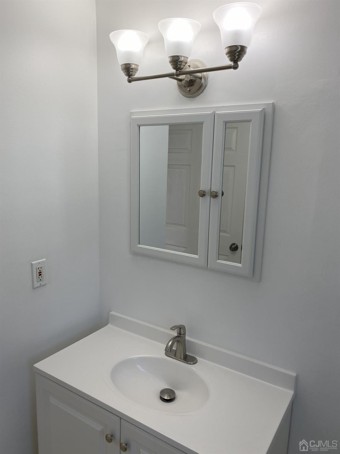 A Zacatin Road Freehold, NJ 07728 - Photo 22 of 25 a bathroom with a sink and mirror
