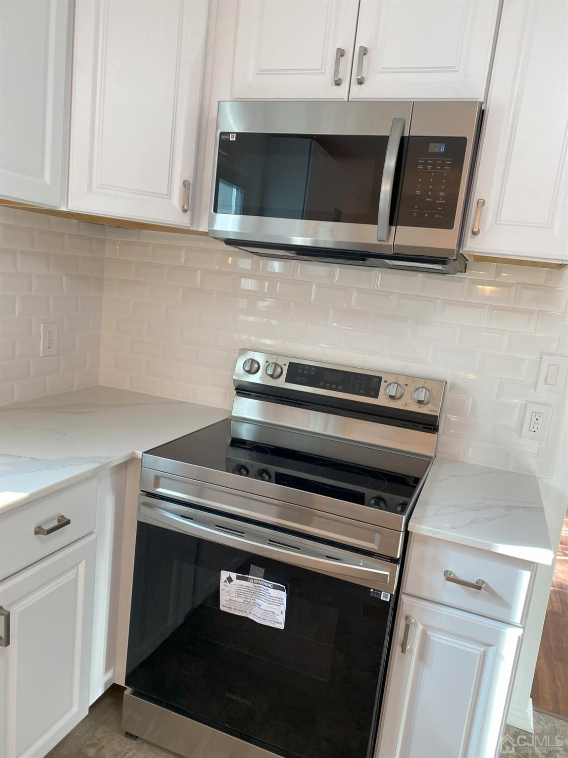 A Zacatin Road Freehold, NJ 07728 - Photo 6 of 25 a stove top oven sitting inside of a kitchen