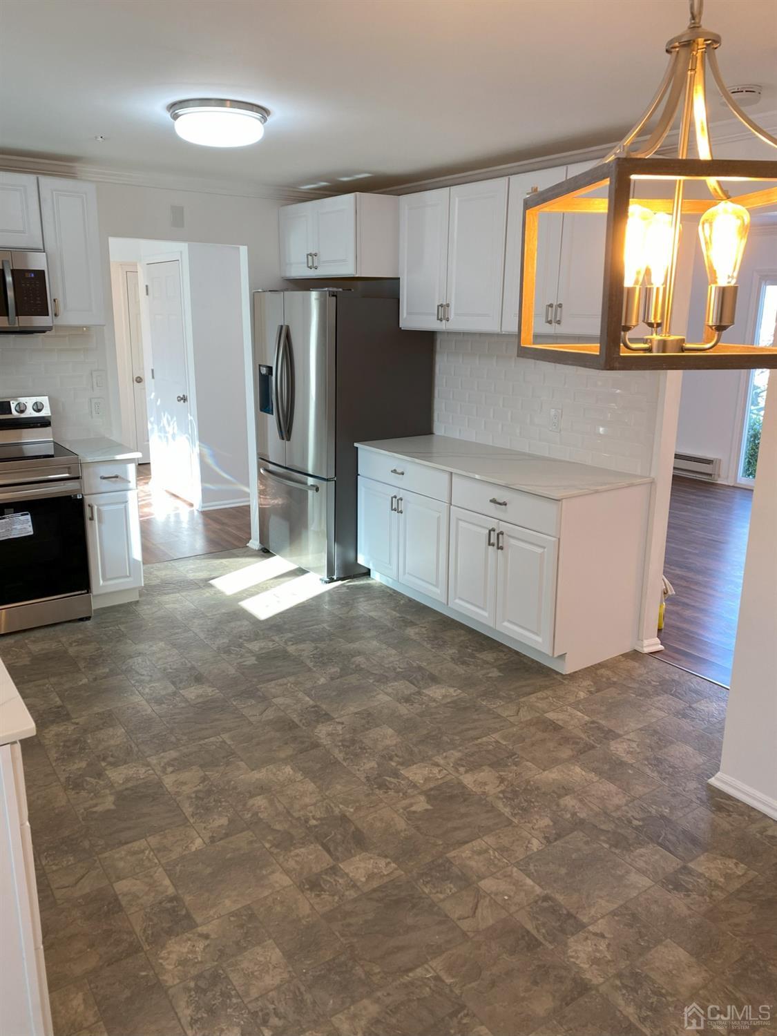 A Zacatin Road Freehold, NJ 07728 - Photo 9 of 25 a kitchen with granite countertop a stove a sink a refrigerator and a stove