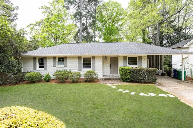 a front view of a house with a garden