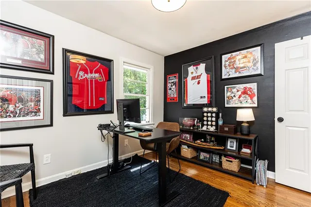 a view of a workspace with furniture and a window