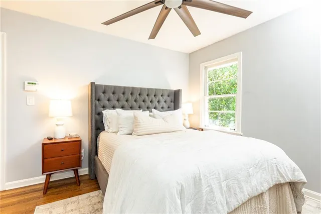 a large bed sitting in a bedroom next to a window