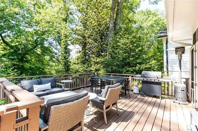 a view of a patio with table and chairs with wooden floor and fence