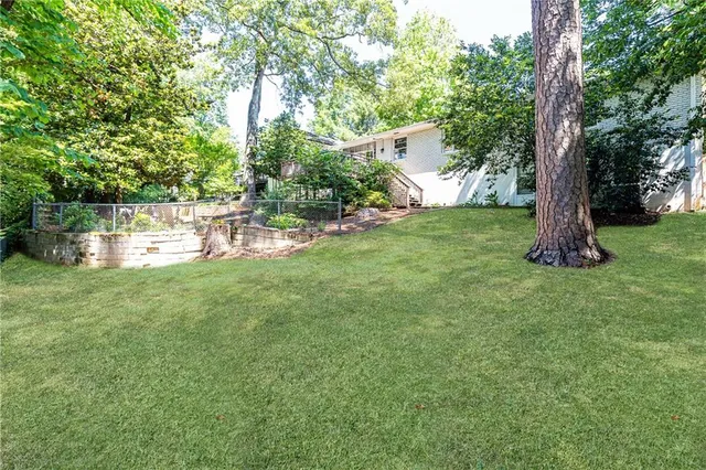 a view of backyard with seating space and trees