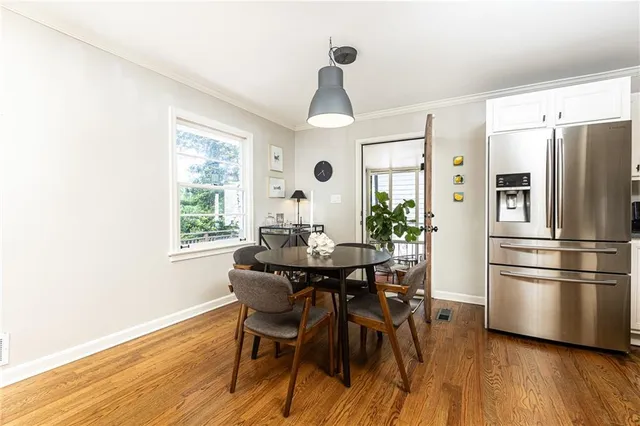 a view of a dining room with furniture window and wooden floor