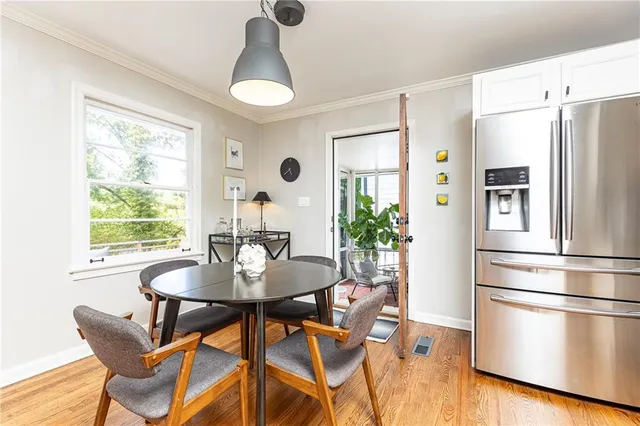 a dining room with furniture a chandelier and wooden floor