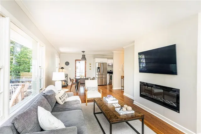 a living room with furniture a flat screen tv and a fireplace