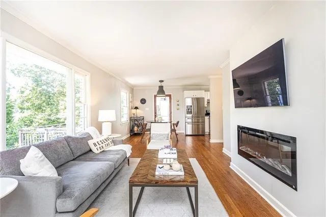 a living room with furniture a flat screen tv and a fireplace