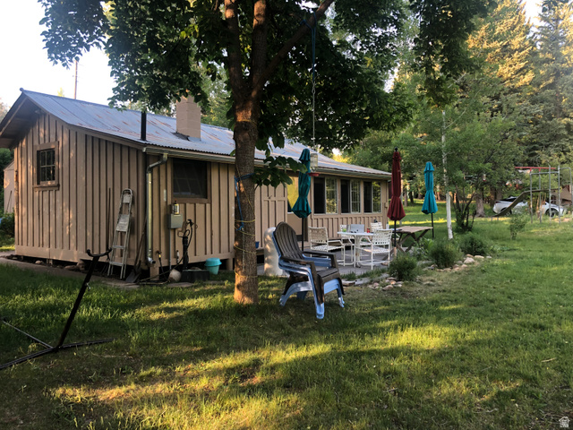 13581 13581st Huntsville, UT 84317 - Photo 10 of 11 Exterior featuring vertical board siding, a corrugated metal roof, and a chimney