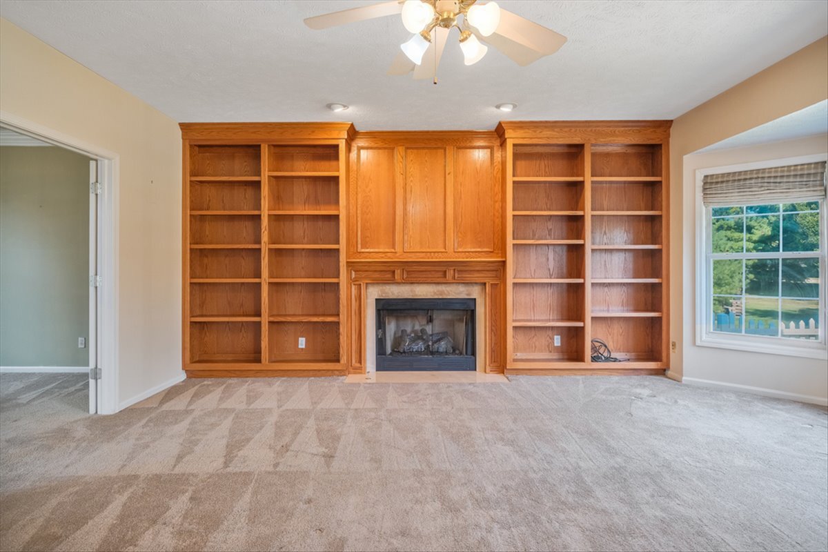 4406 Crossgate Drive Champaign, IL 61822 - Photo 11 of 64 a view of an empty room with a fireplace and cabinet