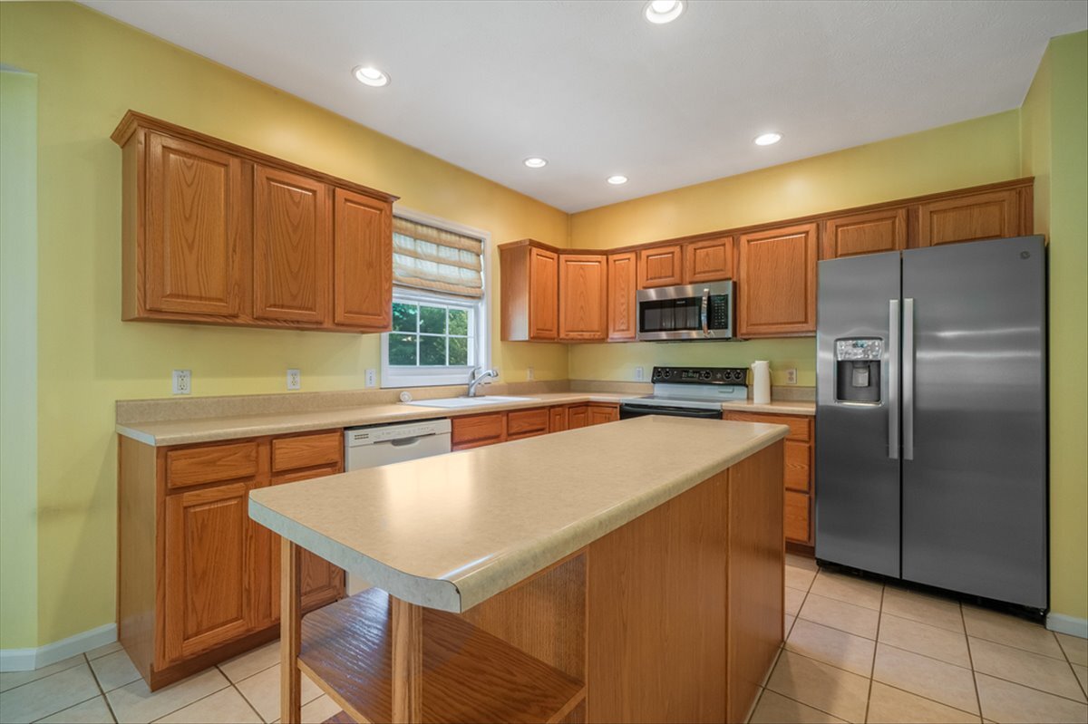 4406 Crossgate Drive Champaign, IL 61822 - Photo 16 of 64 a kitchen with a refrigerator a sink and cabinets