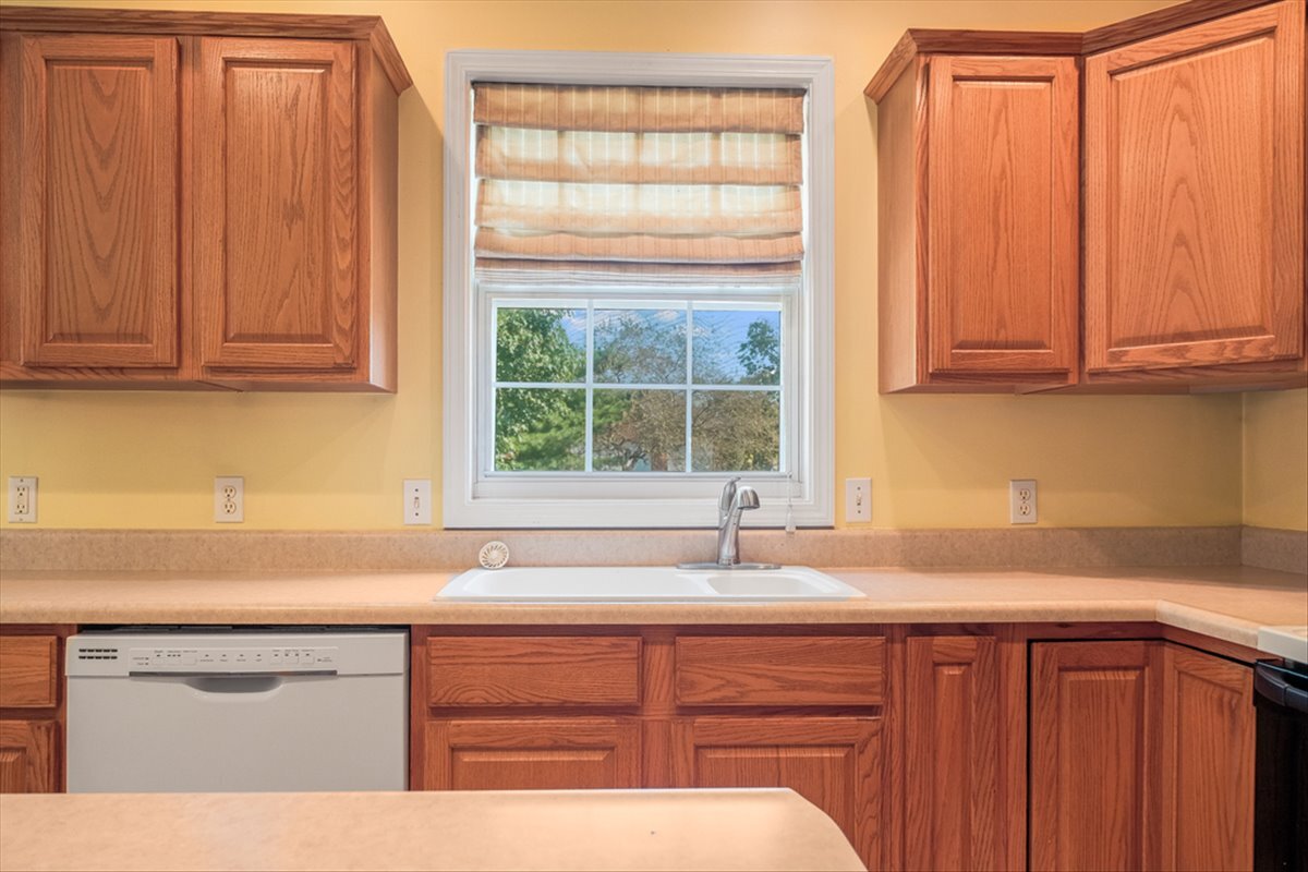 4406 Crossgate Drive Champaign, IL 61822 - Photo 18 of 64 a kitchen with granite countertop a sink window and cabinets