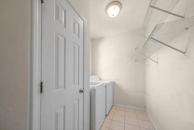 a spacious bathroom with a tub sink and mirror
