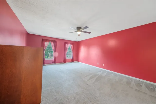 a view of an empty room and a ceiling fan