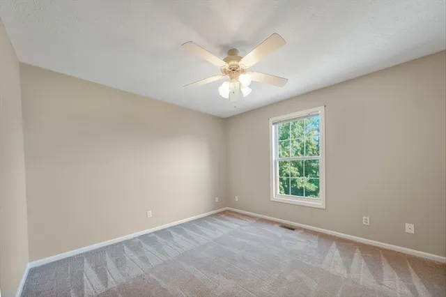 a view of a livingroom with a ceiling fan and couch