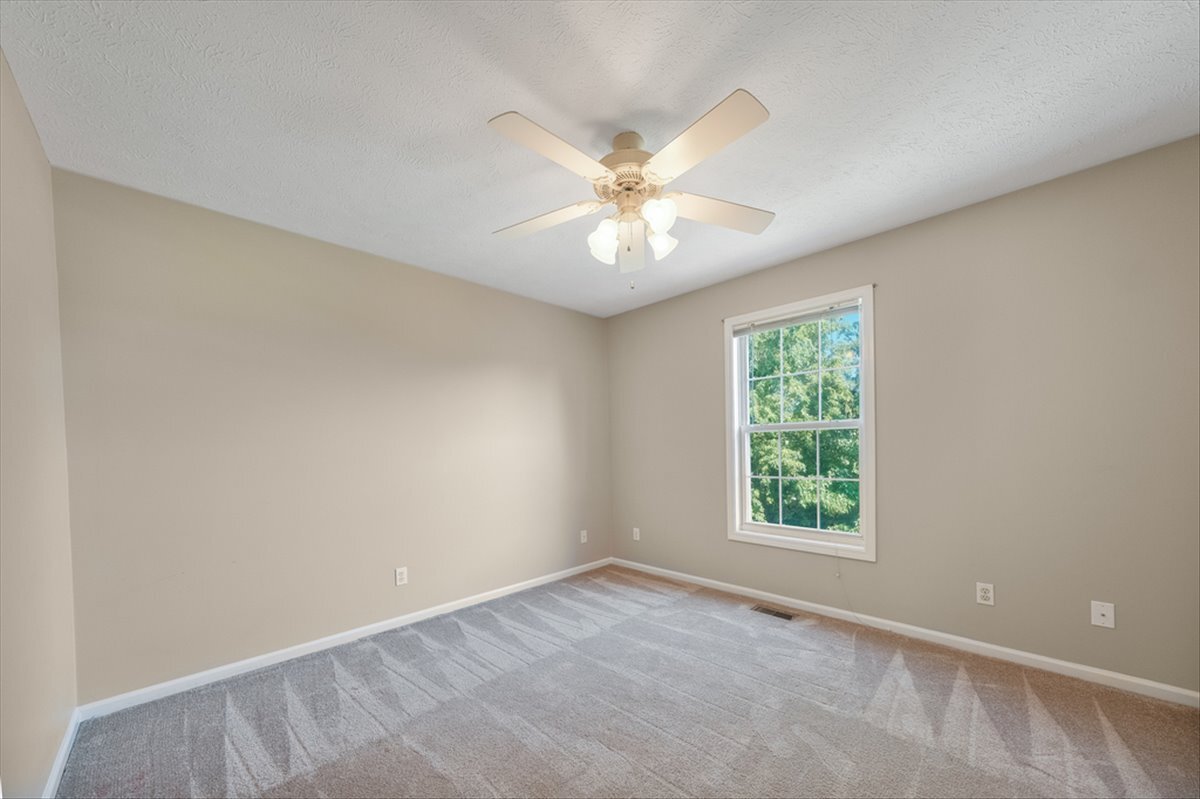 4406 Crossgate Drive Champaign, IL 61822 - Photo 40 of 64 an empty room with a window and a fan
